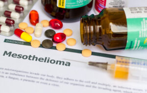 bottle of pills spilled out on papers